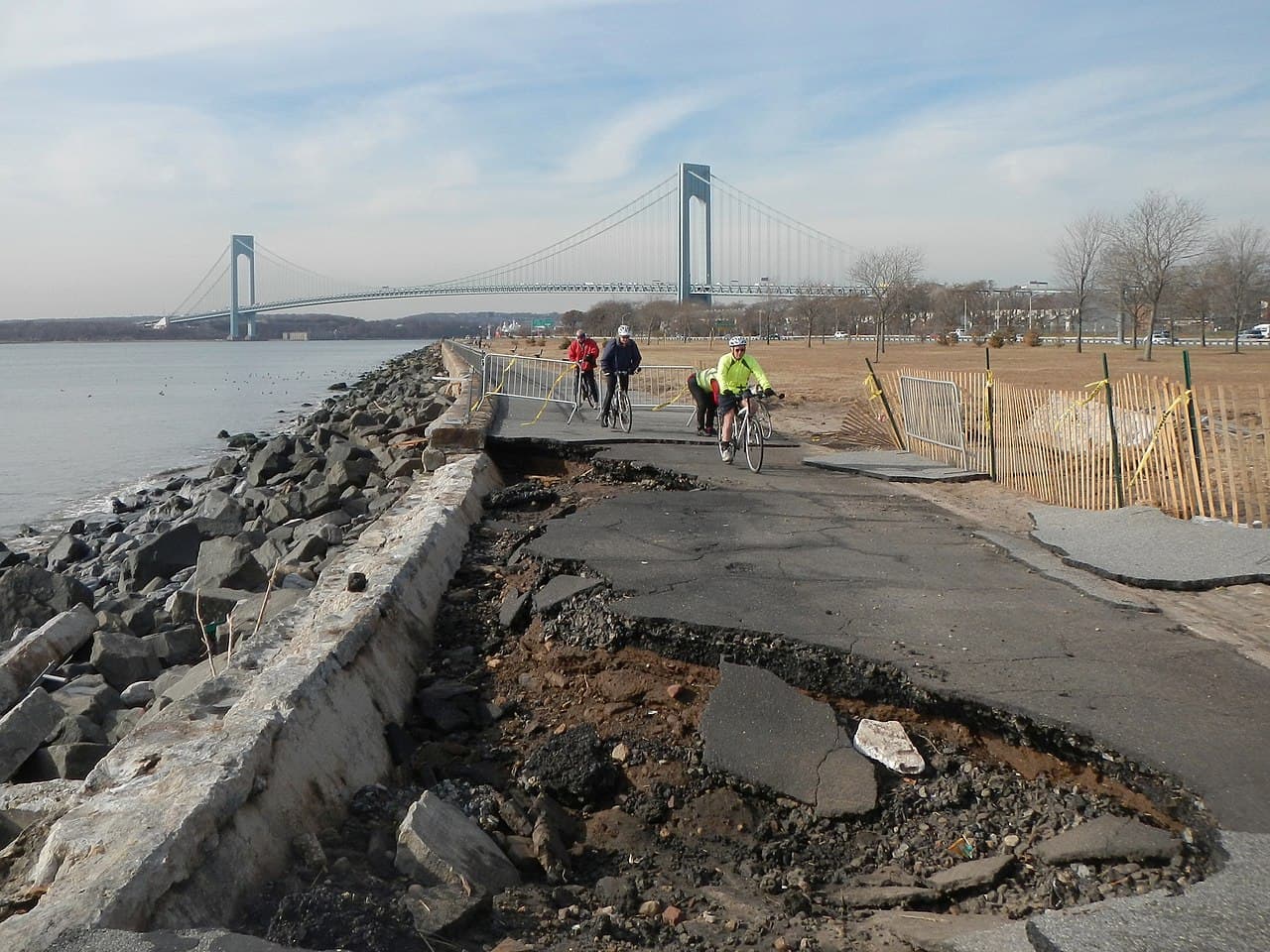 Storm damage crater in a Brooklyn park road after Hurricane Sandy