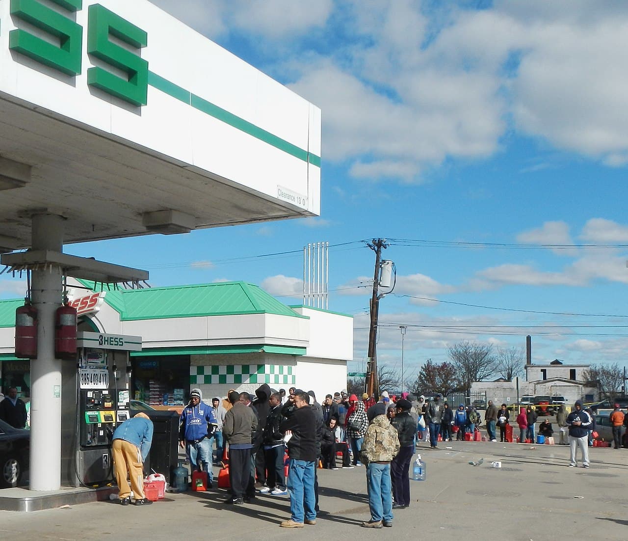 Long line of people with gas cans waiting for fuel in the aftermath of Hurricane Sandy